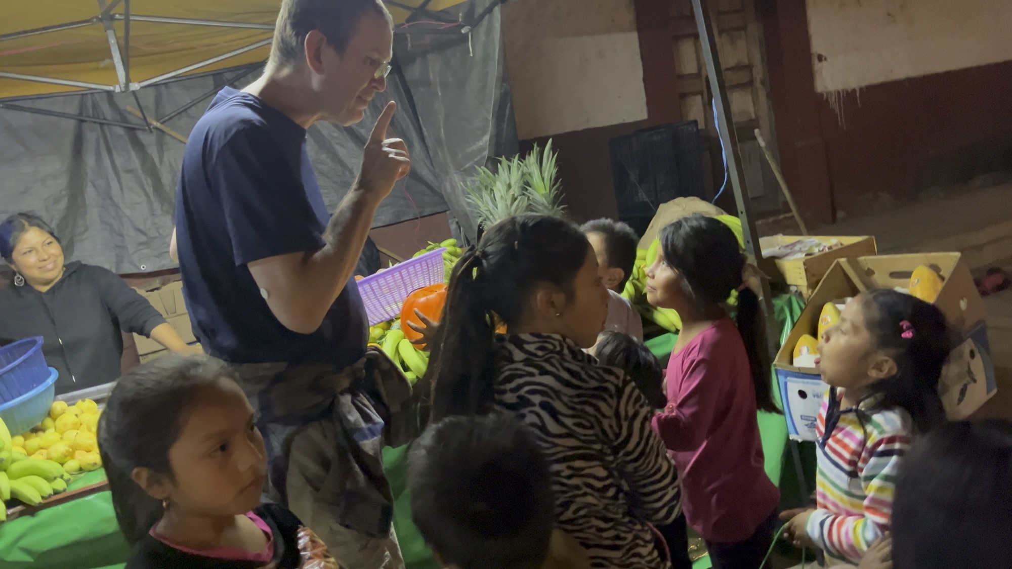 Erik telling the kids “one moment” at the fruit stand